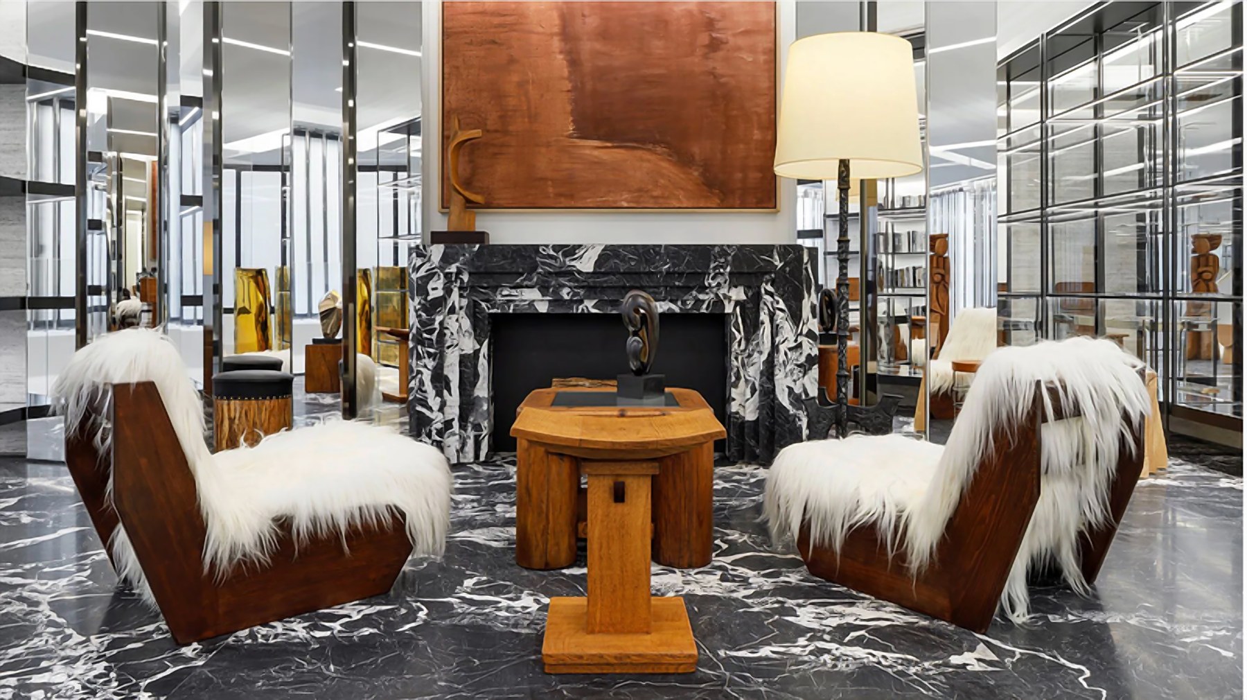 Retail mood board: a lounge with a black and white marble fireplace, shearling chairs and carved timber table