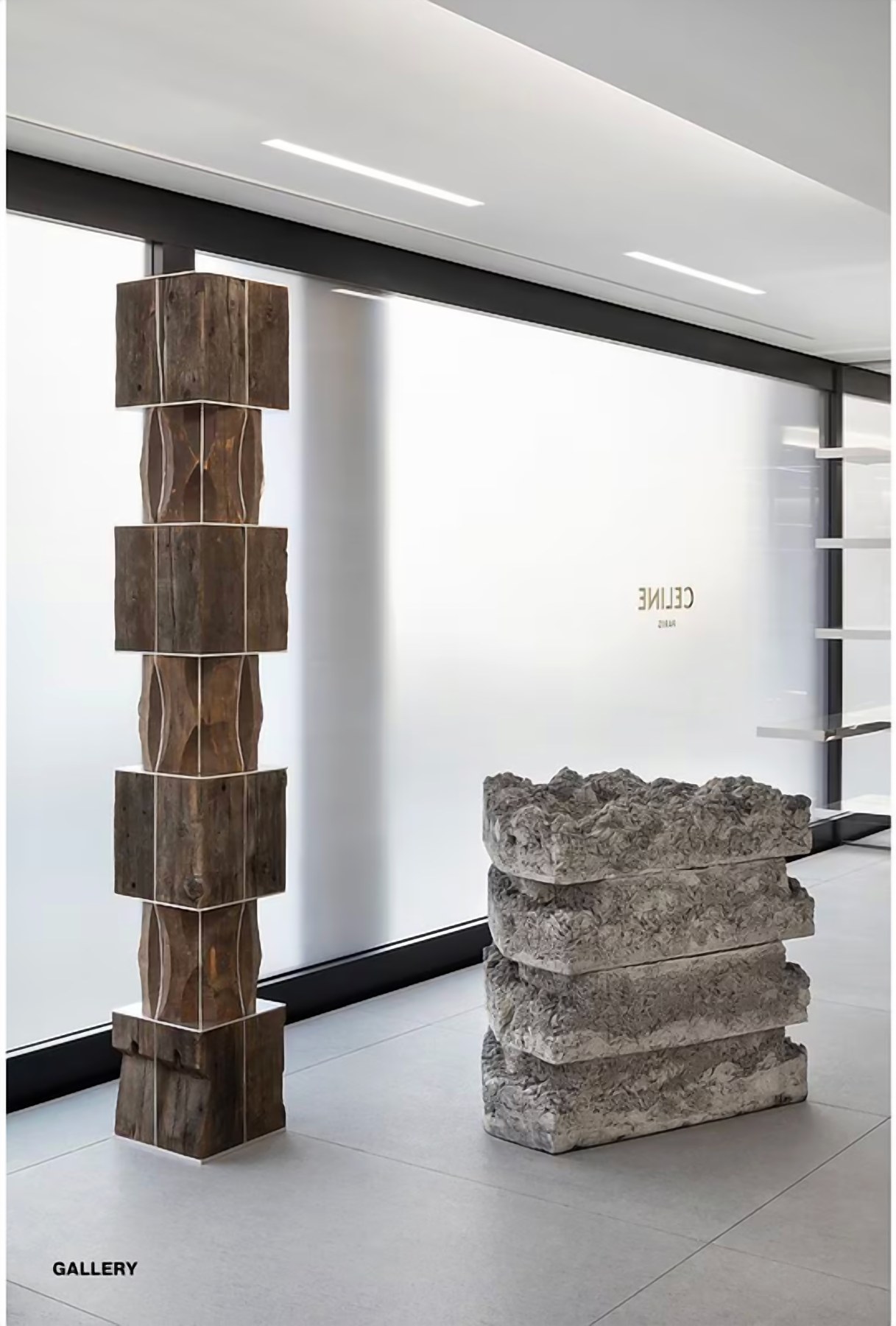 Retail mood board: stacked carved timber column beside a rough stone plinth against a frosted glass wall